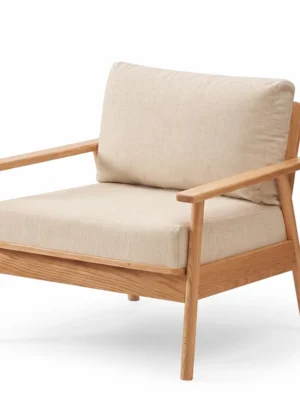 Modern single-seater solid wood accent chair with beige fabric cushions isolated on a white background.