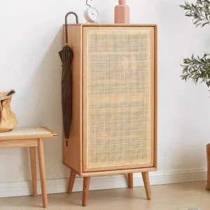 Manna oak entryway shoe cabinet featuring a woven rattan mesh door and umbrella hanging side hook in a home hallway.