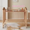 Multi-functional wooden baby crib converted into a kids study writing desk with books and decor.