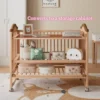 Convertible baby crib repurposed as a three-tier nursery storage shelf displaying storage boxes and plush toys.