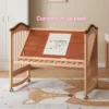 Solid wood convertible crib transformed into an adjustable tilt drawing easel for kids art and painting.