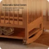 Close-up of retractable swivel casters that easily switch solid wood baby crib into a soothing rocking cradle.