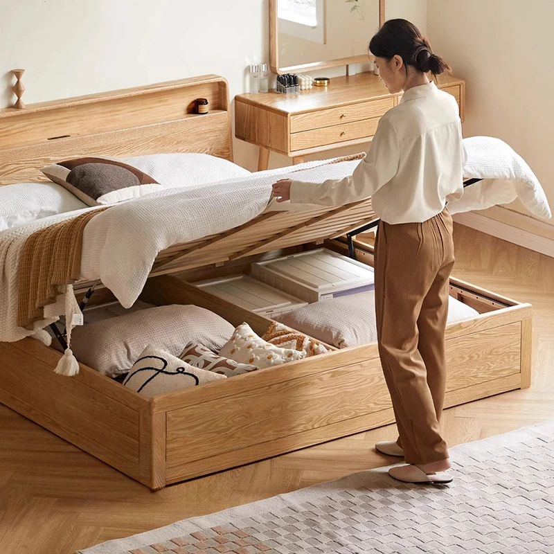 Woman easily lifting hydraulic gas lift bed frame revealing spacious under-bed storage compartment for bedding and organizers.