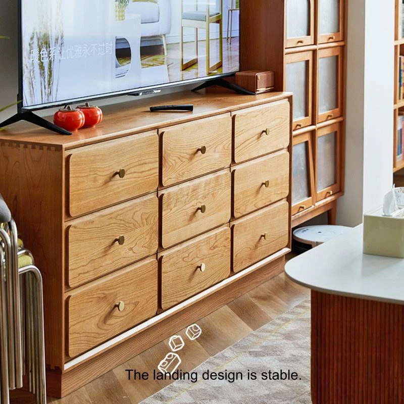 Manna cherry wood 9-drawer dresser used as a low TV credenza with stable plinth base in a living room.