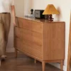 manna-cherry-wood-9-drawer-wide-dresser-side-view Side angle view of Manna cherry wood 9-drawer wide dresser with fluted bottom drawers in a brightly lit room.