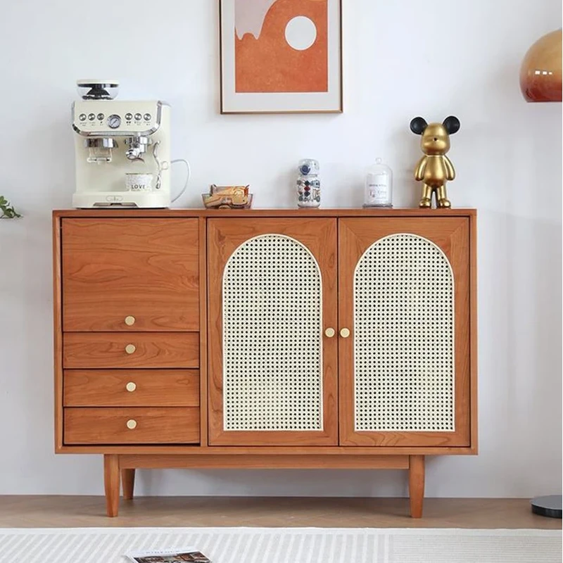 Front view of Manna cherry wood sideboard credenza with arched rattan mesh doors, flip top drawer, and three storage drawers styled with a coffee machine.