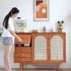 Manna cherry wood sideboard credenza with a person opening the flip-top storage compartment holding small appliances.