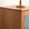 Close-up view of traditional dovetail joint craftsmanship on top corner of Manna cherry wood narrow cabinet.