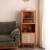 Front view of Manna cherry wood side cabinet featuring top glass display, middle open shelf with coffee grinder, and bottom rattan door.