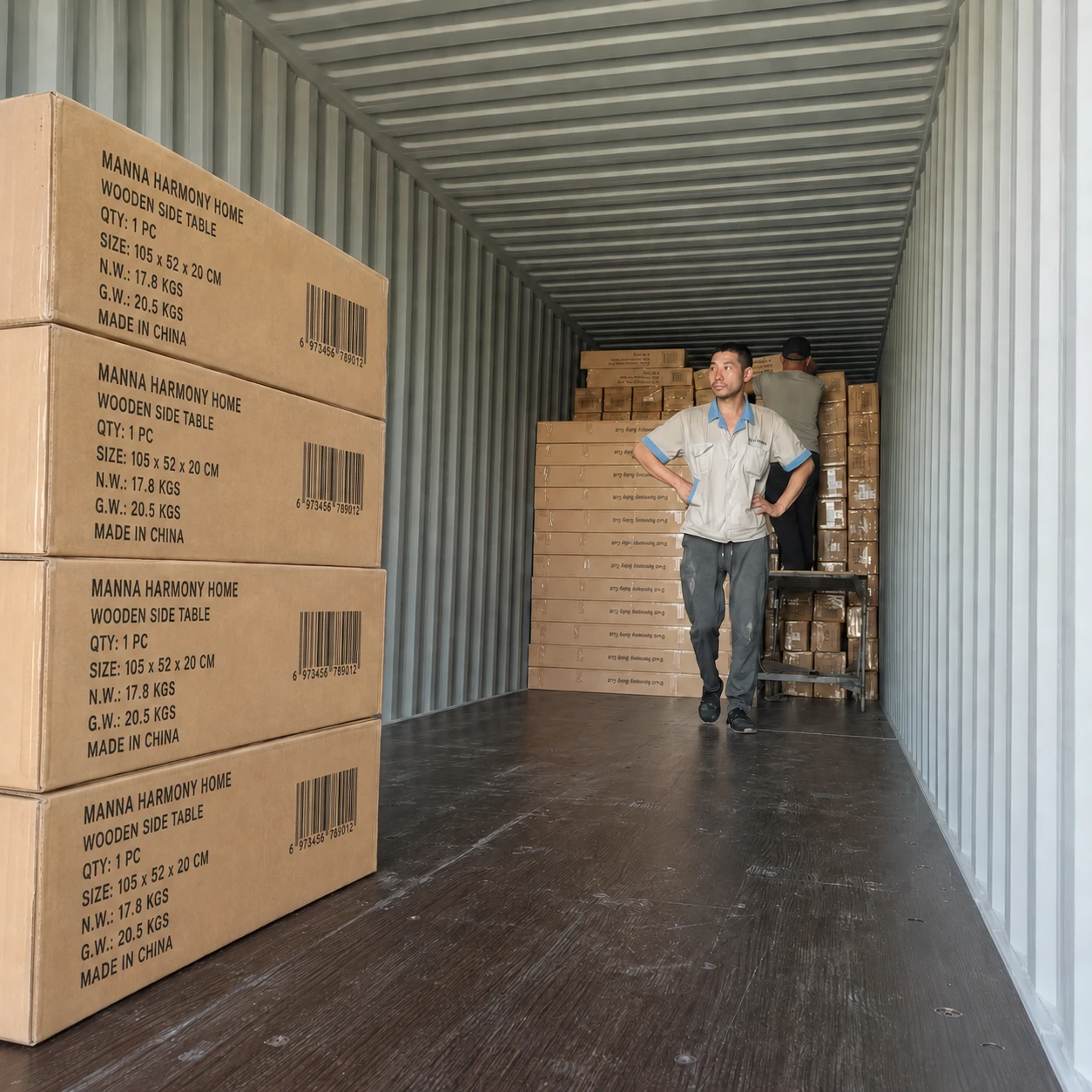 Workers loading Manna Harmony Home boxed solid wood furniture into a sea shipping container for global export.
