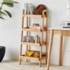 Manna oak 4-tier ladder storage shelf with tray shelves placed next to a writing desk in a bright home office.