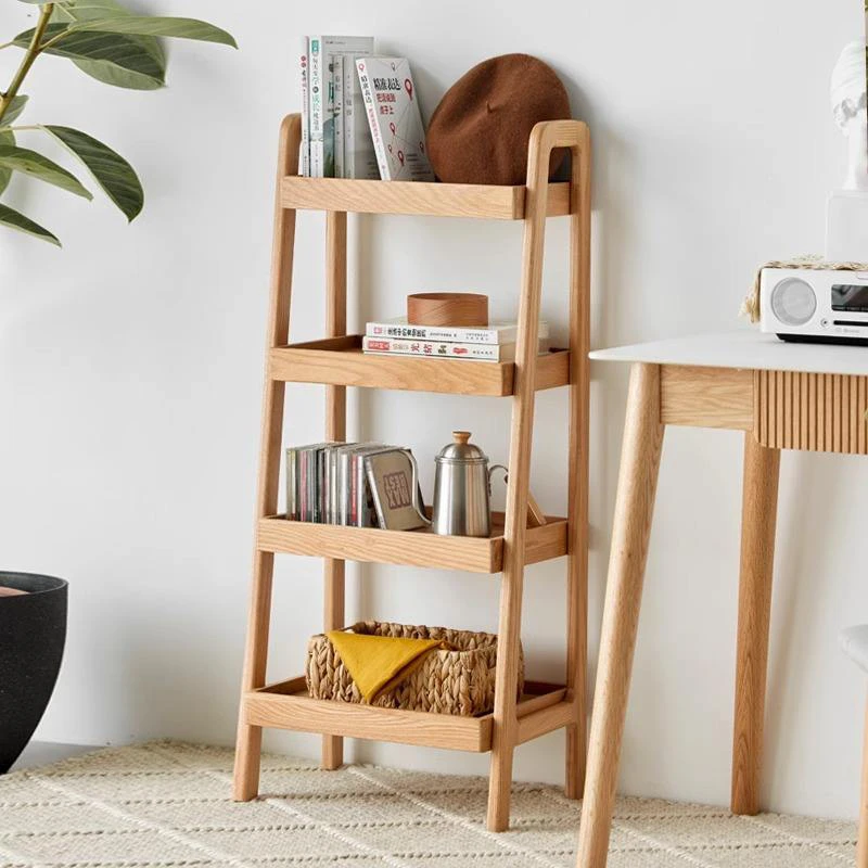Manna oak 4-tier ladder storage shelf with tray shelves placed next to a writing desk in a bright home office.