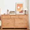 manna-oak-7-drawer-dresser-recessed-pulls-front-view Front view of Manna oak 7-drawer wide dresser with integrated recessed handles styled in a warm, cozy bedroom.