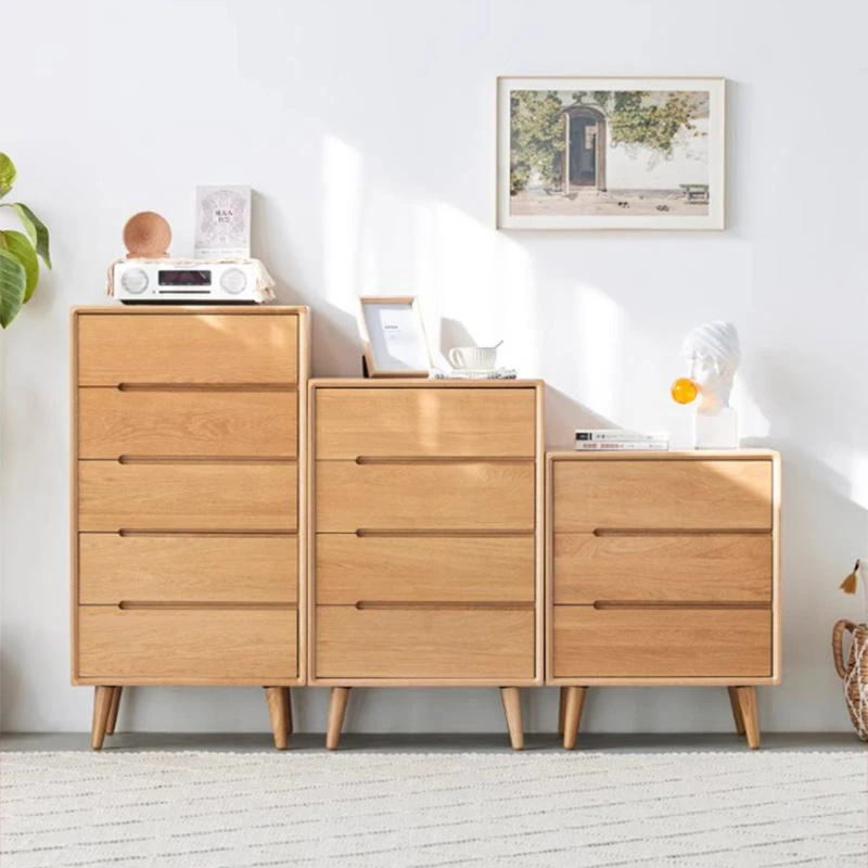 manna-oak-chest-of-drawers-3-4-5-tier-front-view Front view of Manna oak chests of drawers set featuring 3-drawer, 4-drawer, and 5-drawer tall dressers with integrated cut-out handles.