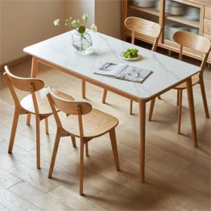 Set of 4 Manna solid oak curved back dining chairs paired with a white sintered stone dining table in a cozy dining room.