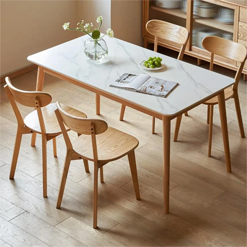 Set of 4 Manna solid oak curved back dining chairs paired with a white sintered stone dining table in a cozy dining room.