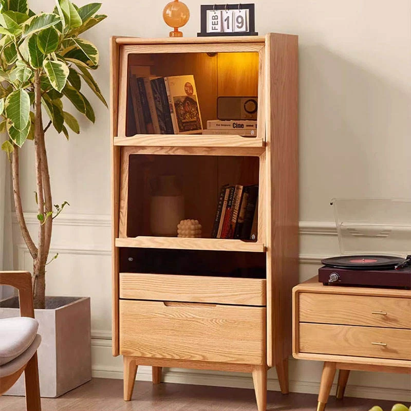 manna-oak-glass-flip-door-bookcase-led-light-living-room Manna oak glass flip door bookcase with interior warm LED lighting styled next to a vinyl record player in a living room.