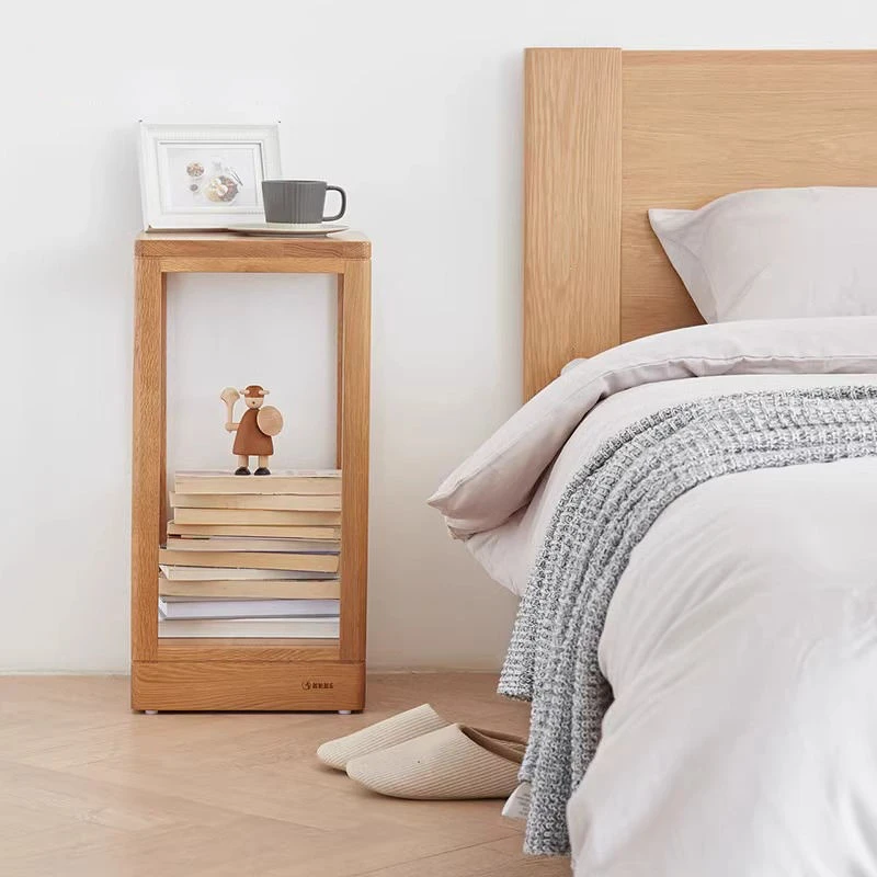 Close-up detail of smooth rounded top corner and natural wood grain on Manna oak minimalist open frame side table.