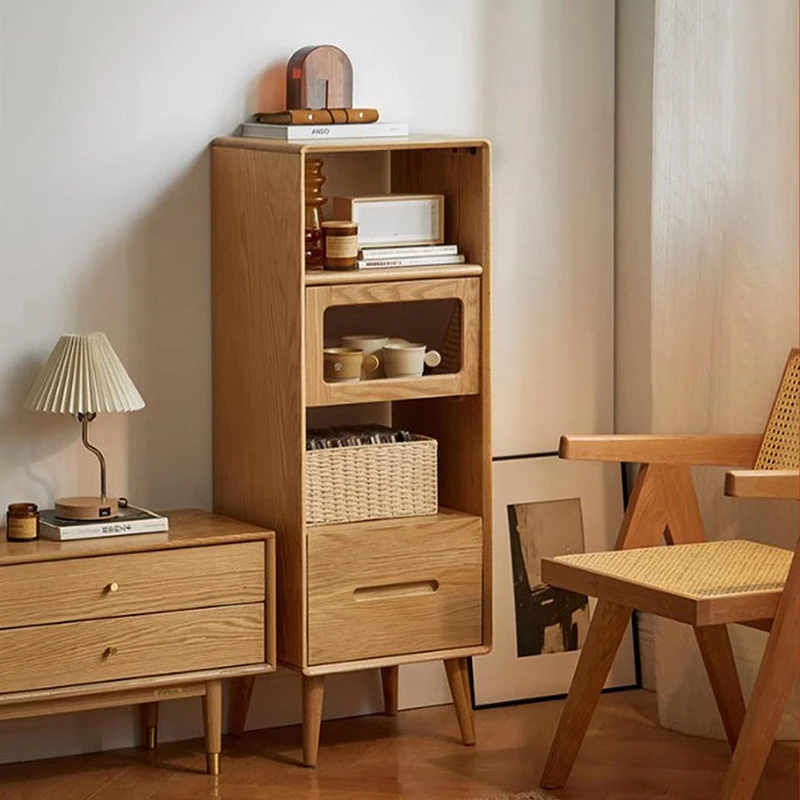 manna-oak-narrow-accent-cabinet-bedroom-sideboard Manna oak narrow accent cabinet placed next to a bedroom sideboard dresser and a rattan chair.