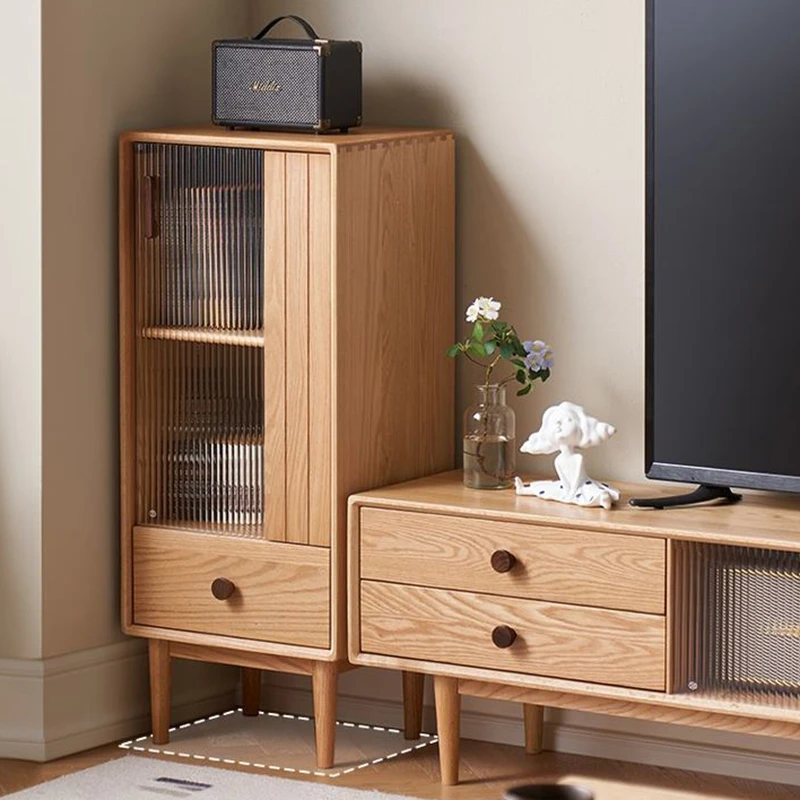 Manna oak narrow fluted glass cabinet styled next to a wooden TV console in a living room corner showing compact floor space usage.