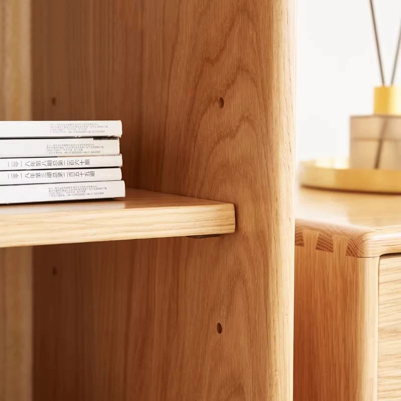 manna-oak-narrow-glass-display-cabinet-craftsmanship-detail Close-up detail of adjustable shelf pins, natural oak grain, and traditional dovetail joinery on Manna narrow glass display cabinet.