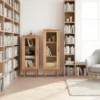 manna-oak-narrow-glass-display-cabinets-library-study-room Manna oak narrow glass display cabinets in two heights styled next to tall open bookcases in a light-filled home library.