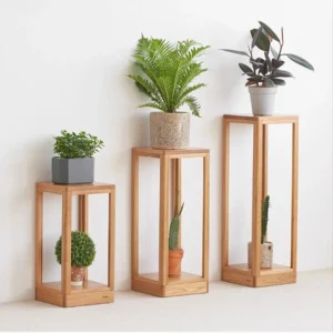 manna-oak-open-frame-nightstand-bedroom-lifestyle Manna oak open frame side table used as a bedside nightstand holding stacked books, a small ornament, and a coffee cup.