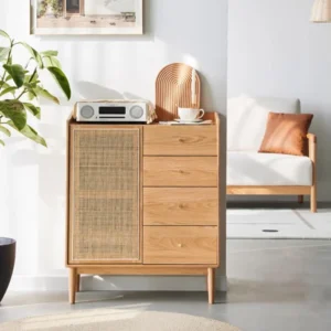 Manna oak accent cabinet with rattan mesh door and 4 drawers styled in a bright living room next to a white sofa.
