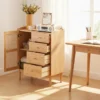 manna-oak-rattan-accent-cabinet-home-office-desk Manna oak rattan door cabinet placed beside a matching wooden writing desk in a sunlit home office.