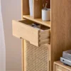 Close-up detail of smooth sliding drawer with traditional dovetail joinery on Manna oak rattan narrow side cabinet.