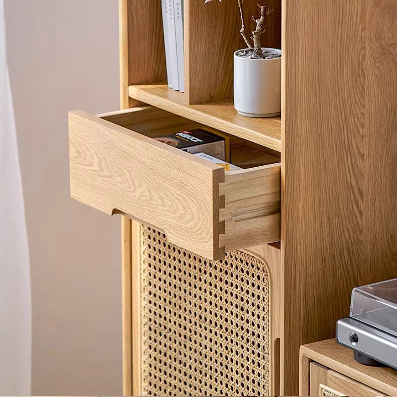 Close-up detail of smooth sliding drawer with traditional dovetail joinery on Manna oak rattan narrow side cabinet.