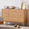 Manna oak multi-drawer sideboard credenza placed beside a bed as a spacious bedroom storage cabinet.