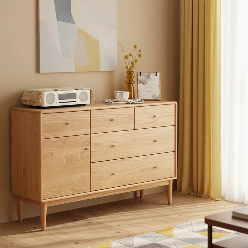 Manna oak sideboard credenza featuring top small drawers, large storage drawers, and a single door cabinet styled in a warm living room.