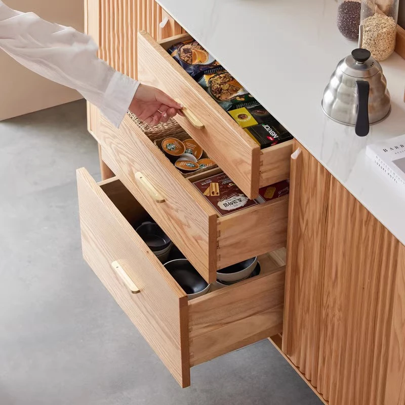 manna-oak-sideboard-drawers-open-storage-detail Close-up view of open solid wood drawers on Manna oak sideboard credenza showing organized coffee and tea storage.