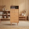 manna-oak-tall-dresser-open-hutch-front-view Front view of Manna oak tall chest of drawers with top open shelf, featuring asymmetrical top small drawers and tapered legs.