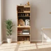 Front view of Manna oak tall kitchen pantry hutch cabinet with coffee maker, toaster oven, and pegboard in a dining room.