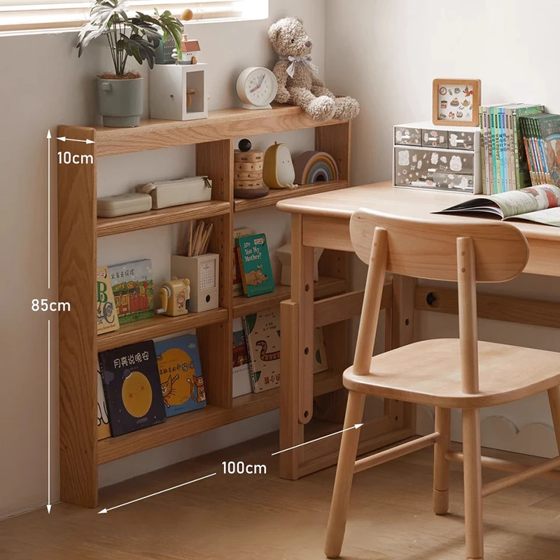 Manna oak ultra-slim 10cm deep bookcase placed beside a wooden study desk in a child's bedroom.