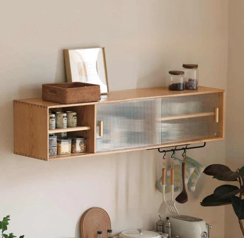 manna-oak-wall-mounted-fluted-glass-cabinet-hanging-rod-detail Front view of Manna oak wall-mounted fluted glass cabinet featuring bottom metal hanging rod with hooks for kitchen utensils.