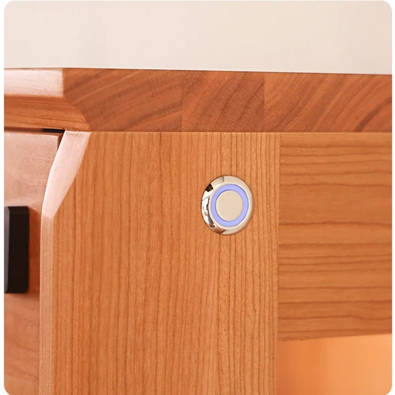 manna-turin-display-cabinet-touch-ambient-light-button-detail Close-up view of the touch-sensitive LED ambient light control button on Manna Turin cherry wood display cabinet.