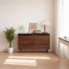 Manna black walnut 6-drawer dresser with fluted wave detail styled in a bright modern living room.