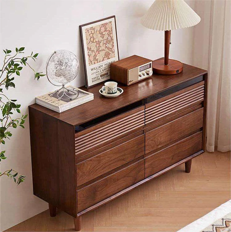 Top angle view of Manna black walnut 6-drawer dresser showcasing rich wood grain and decorative items on top.