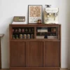 Front view of Manna black walnut credenza sideboard styled as a home coffee station with an espresso machine and radio.