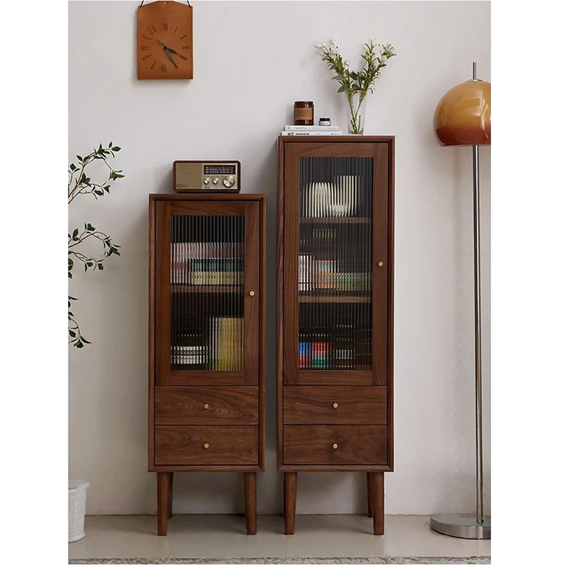 Front view of Manna black walnut narrow single door cabinets with fluted glass and bottom drawers in two height options.