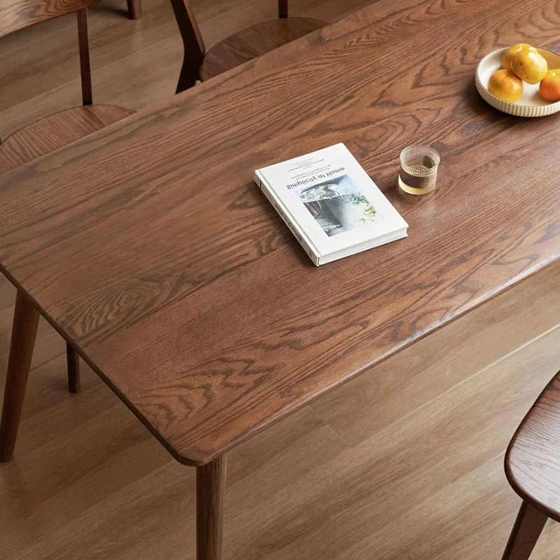 Close-up view of clear natural grain texture and smooth rounded safety edges on a solid wood table top.