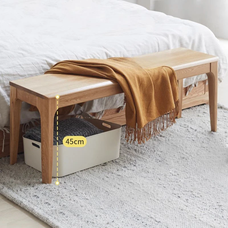 manna-oak-dining-bench-bedroom-size-guide Oak bench at the foot of a bed with a mustard throw and a forty five centimetre height marker showing seat height.
