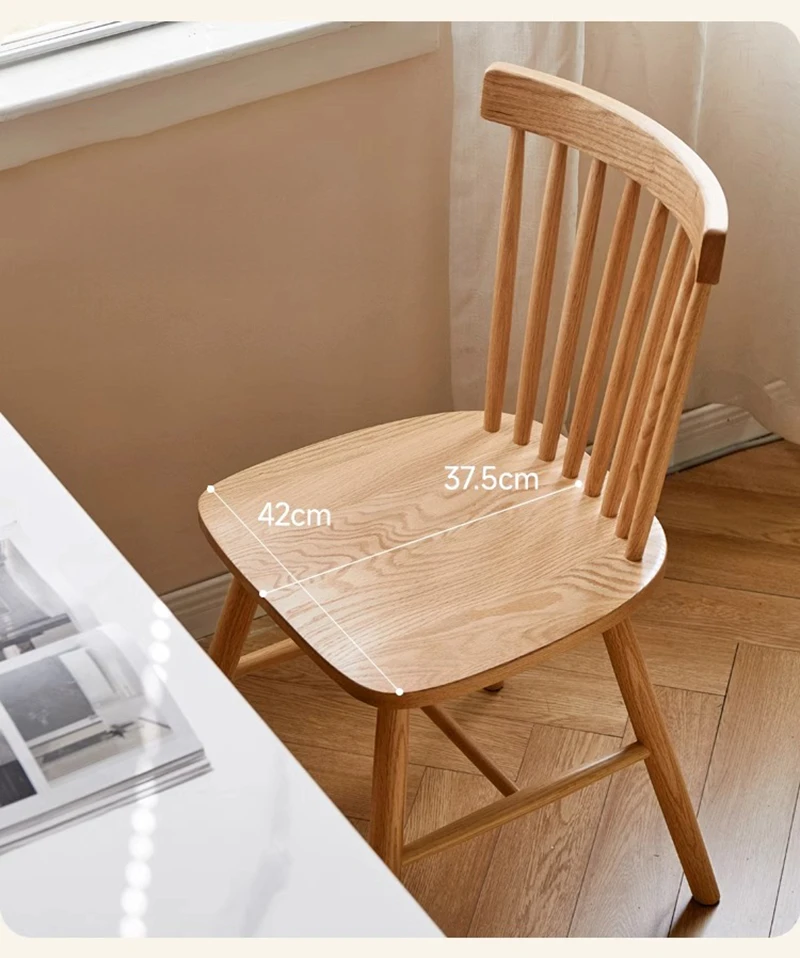 Main view of solid oak dining chair with spindle back and wooden seat near a white table with 42cm and 37.5cm overlays.