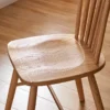 Close up of solid oak dining chair wooden seat with saddle carved grain and 42cm seat width measurement overlay.