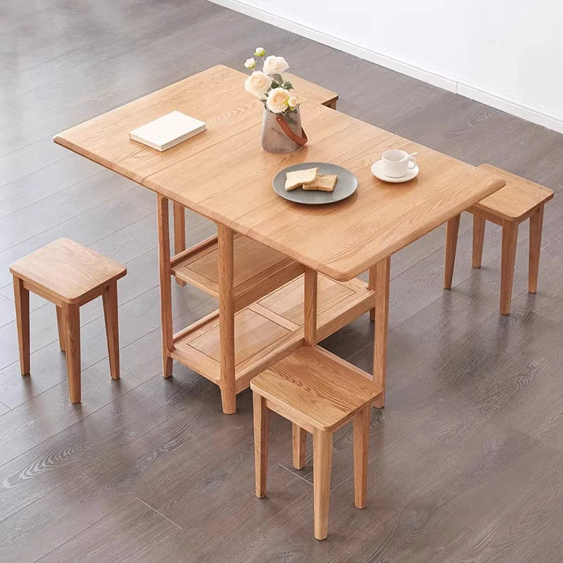 Living room scene with a folding oak dining table fully extended and three solid oak stools arranged around it.