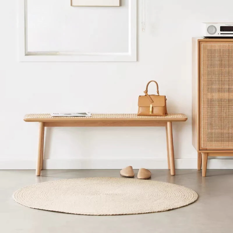 manna-oak-rattan-dining-bench-hallway Natural oak rattan cane bench used as hallway seating beside a rattan cabinet with a handbag resting on top.