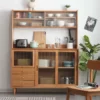 manna-oak-sideboard-three-drawer-glass-hutch-front-view Front view of an oak sideboard with fluted glass sliding doors, three drawers stacked at the lower left and a glazed display hutch.